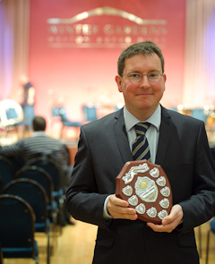 John Swindells, MD holds the trophy
