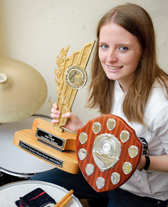 Carly Taylor shows off the band's shield and her own trophy